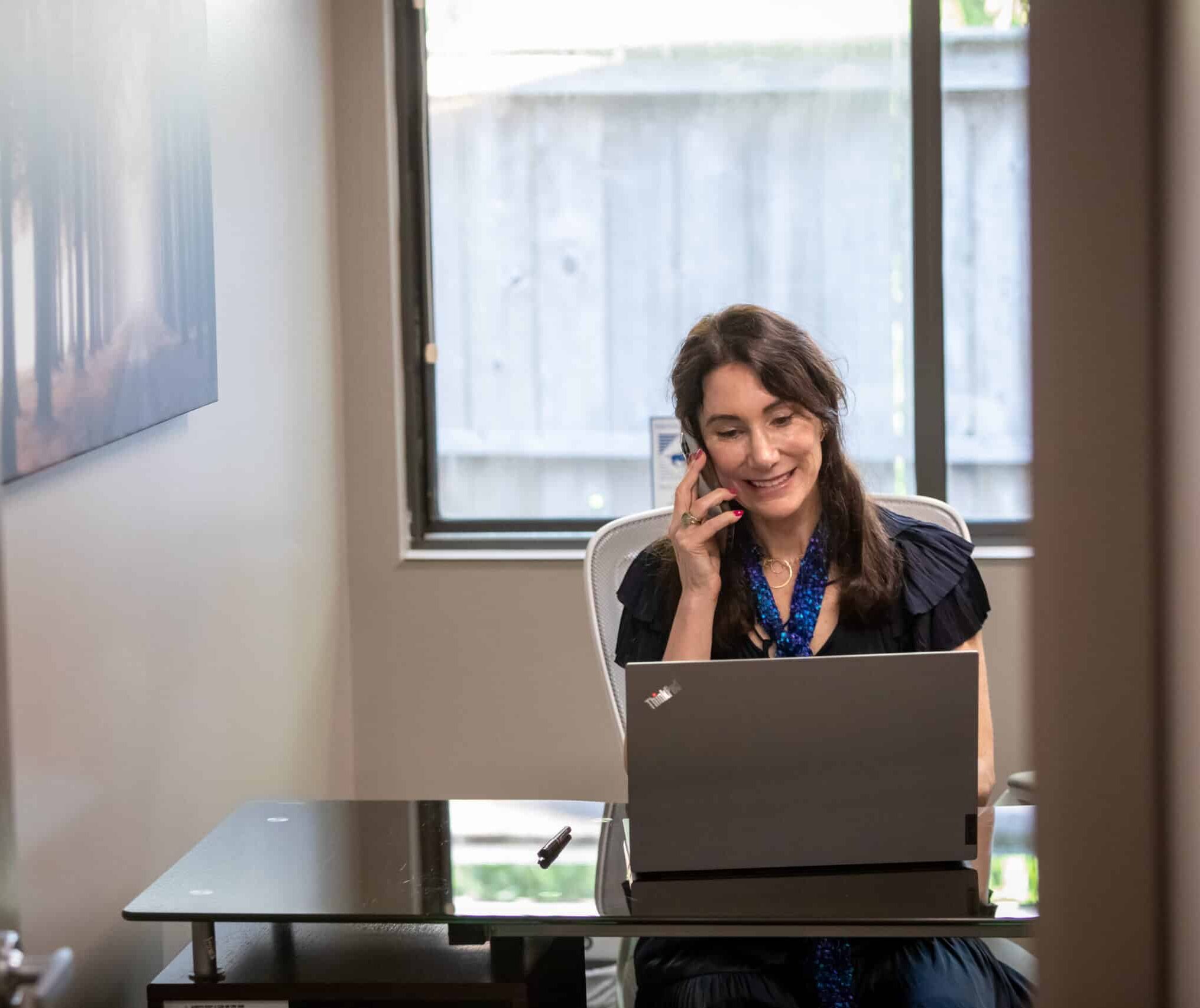 New England Smart Energy Group Happy Lady making phone calls.